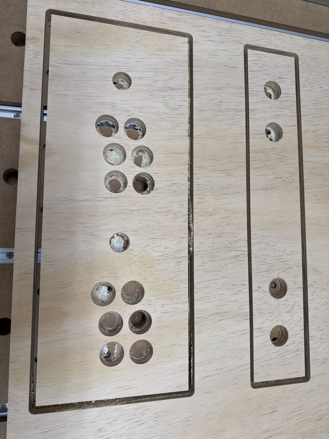 Replacement arcade control panel and front panel still on the CNC bed