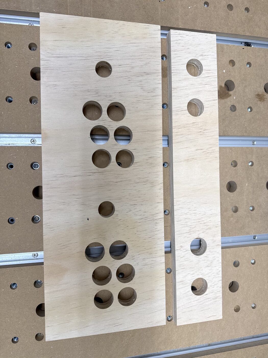 Cut plywood control panel and front panel removed from the CNC bed