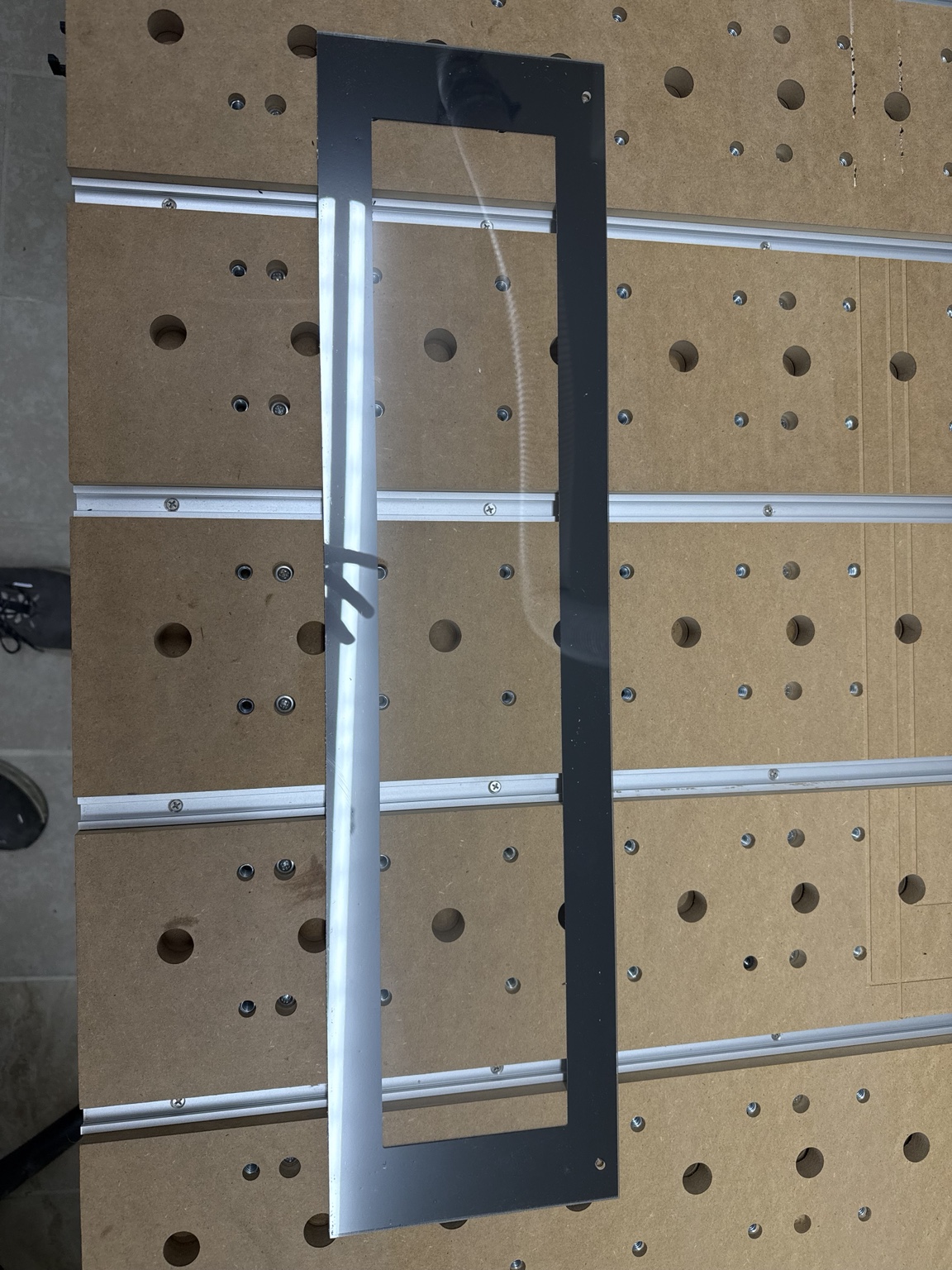 Full black ABS marquee display mask with rectangular window and mounting holes on Gary's workbench